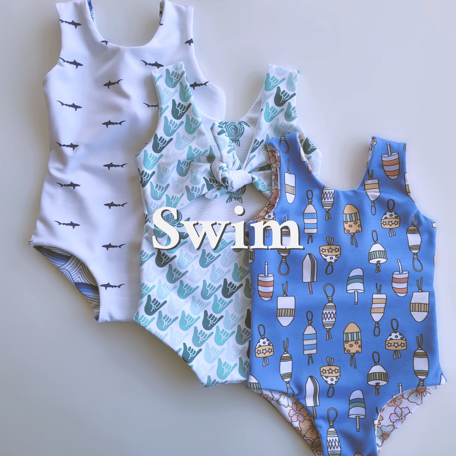 Multiple ethically made swim shorts with nautical prints.