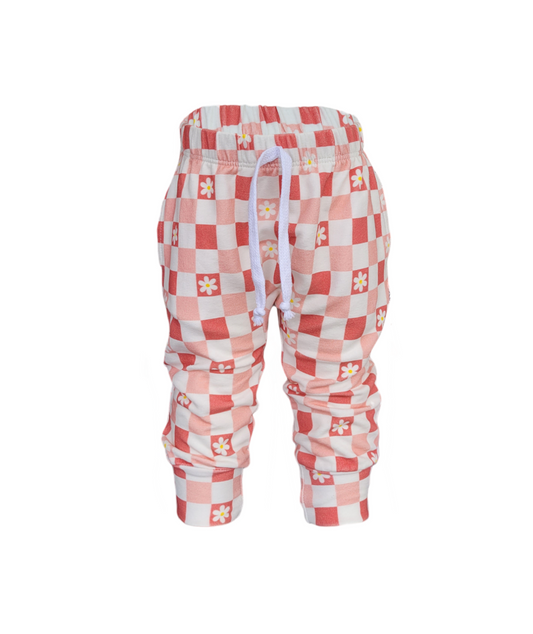 Front of Pink Daisy Sweatpants. Organic white and Pink Checkered sweatpants with white daisy's. 