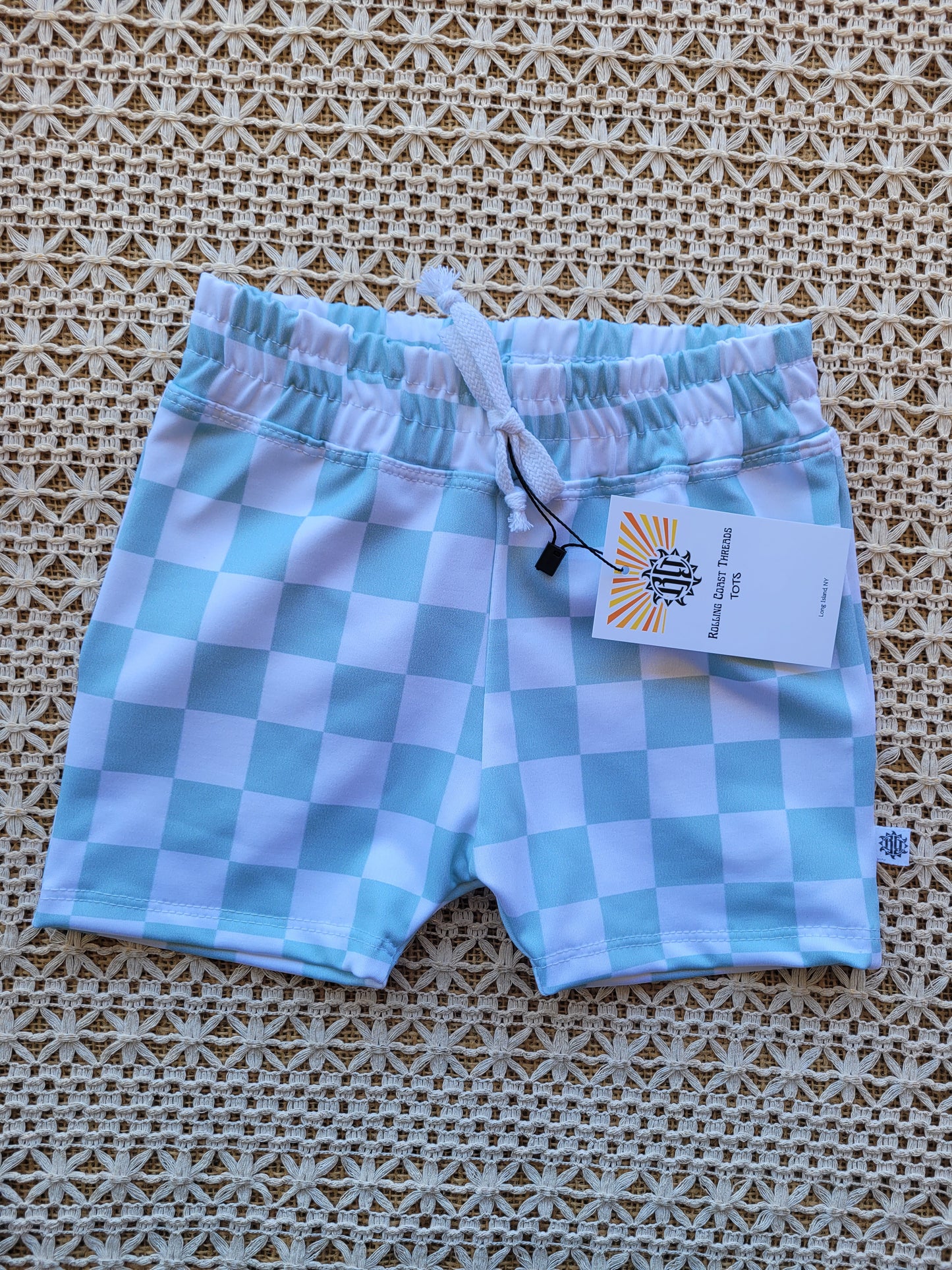Front of boys white and mint green checkered swim shorts