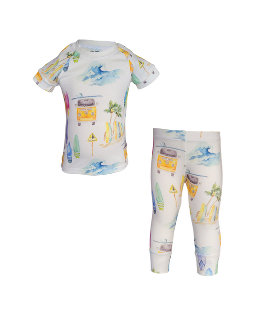 Front of Surfs Up Pajama Set. Organic white short sleeve and pant set with colorful surfboards, vans and palm trees.