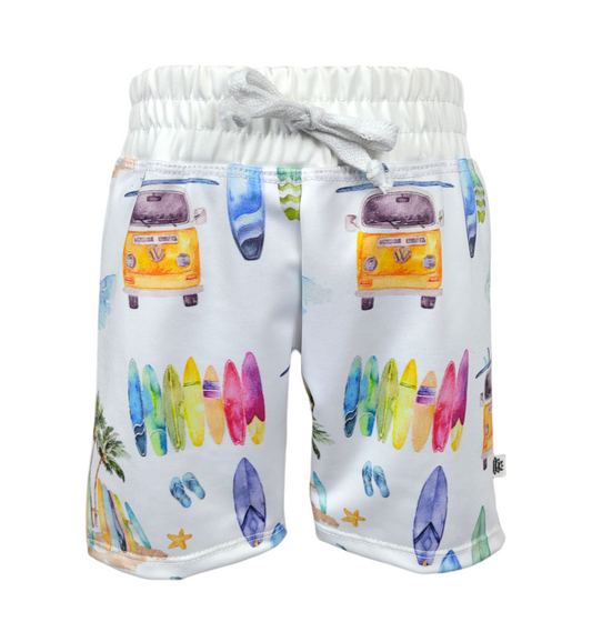 Front of sustainable boys white swim shorts with colorful surfboards