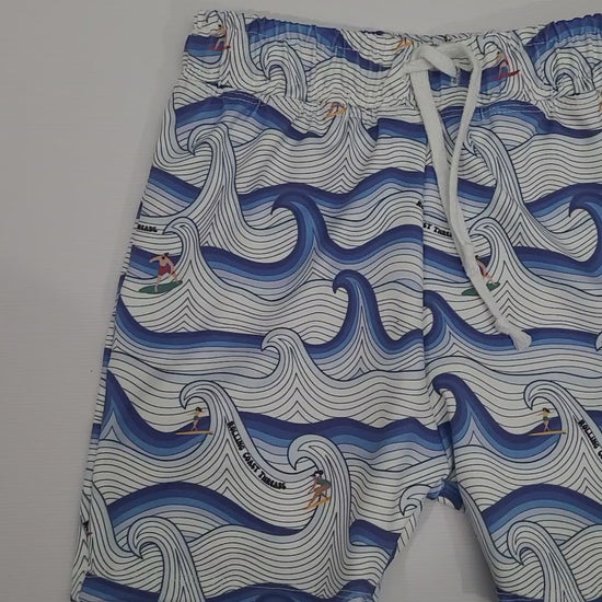 Boys swim shorts. White and blue waves with surfers